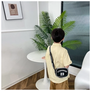 Close-up of black nylon kids crossbody bag featuring white STARSBRUG 23 lettering print