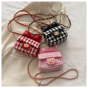 Detailed close-up of mini tweed crossbody bags with bow accents and gold metal turn locks