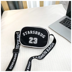 Close-up of black nylon kids crossbody bag with white Starsbrug 23 letter printing