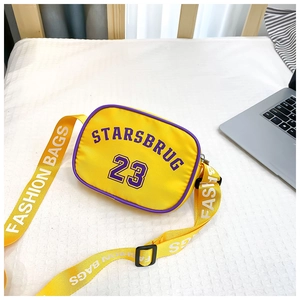 Close-up of a yellow nylon kids crossbody bag featuring purple STARSBRUG lettering