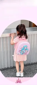 Pink kids mermaid backpack with purple trim shown on small model for daily school use