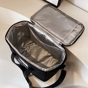 Multifunctional black mommy bag with insulated liner and mesh pockets for milk bottles