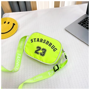 Detail of neon green nylon kids crossbody bag with black letter print and wide strap