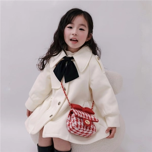 Girls tweed crossbody bag with bow detail paired with elegant white woolen coat