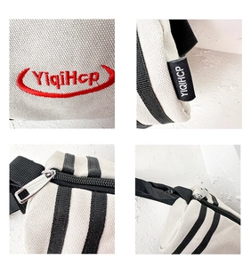 Detailed views of beige canvas crossbody bag with red embroidery and metal zipper