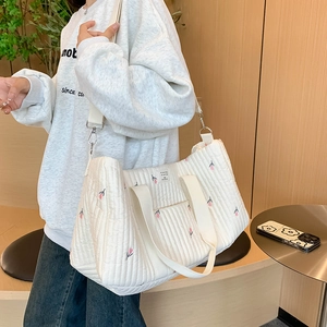 Quilted tote bag with tulip embroidery, spacious design for travel and baby essentials