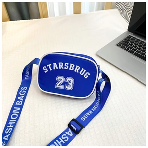 Detailed macro view of a blue nylon kids crossbody bag with white STARSBRUG lettering