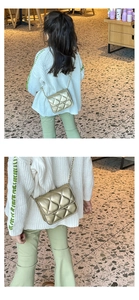 Detail of a child's quilted gold chain crossbody bag showing metallic finish and stitching