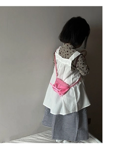 Detailed view of pink mini crossbody bag for kids with cute bow decoration