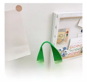 Detail of reinforced wide green handle and high-quality nylon webbing on a kids backpack