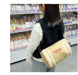 Kids yellow canvas bucket bag with striped pattern and letter embroidery detail