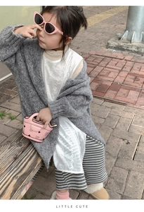 Close-up of a girl wearing a grey cardigan and pink mini teddy bear print handbag