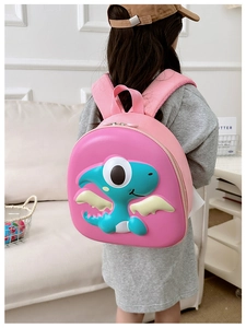 Pink children's hardshell backpack featuring a 3D embossed cartoon dinosaur and wings