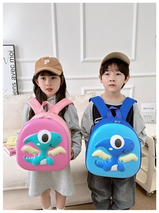 Detail of 3D dinosaur cartoon hard shell backpacks in pink and blue for kids