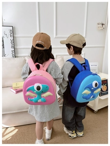 Close-up of lightweight dinosaur eggshell backpacks for kids in pink and blue colors