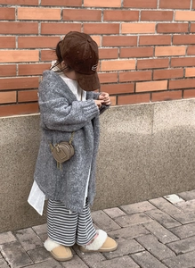 Toddler girl in gray knit cardigan with brown round leather crossbody bag and stylish outfit