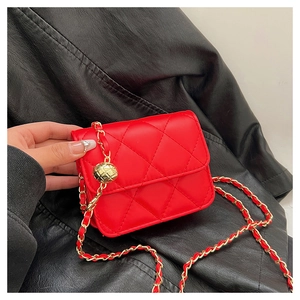 Detailed view of red quilted mini crossbody bag with gold adjustable ball chain strap