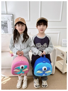 Detailed view of pink and blue 3D dinosaur hardshell backpacks for toddlers