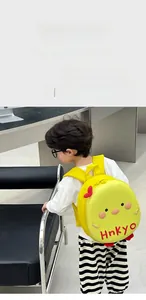 Detail of yellow eggshell backpack showing the 3D cartoon bird design and Hnkyo embroidery