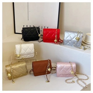 Detailed row of mini quilted chain bags in seven colors on a white display stand