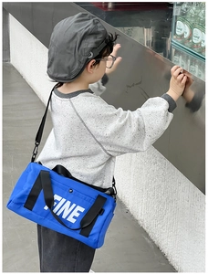 Blue cylindrical kids canvas crossbody bag featuring white FINE letter print and adjustable strap