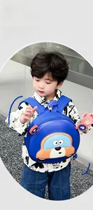 Detail view of a lightweight blue cartoon car backpack on a child's shoulder