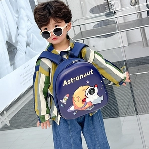 Blue hardshell kids backpack with astronaut print worn by a stylish toddler boy