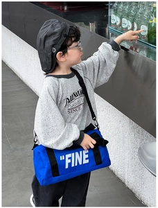 Detail of blue cylindrical canvas bag for kids with FINE print and adjustable strap