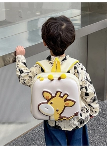 Close-up of a 3D cartoon giraffe backpack showing ergonomic straps on a toddler
