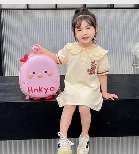 Pink cartoon bird eggshell backpack shown by a young girl on a minimal stage