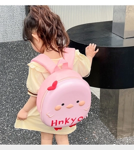 Detailed close-up of a pink eggshell backpack with a cute 3D cartoon bird design