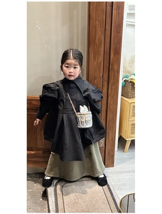 Détail du sac seau à chaîne cœur argenté assorti à une robe matelassée noire