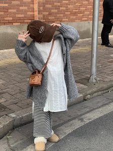 Toddler model showcasing cartoon bear handbag with knit cardigan and vintage urban outfit