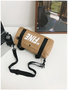 Detail of khaki cylindrical canvas bag with white FINE print and black nylon strap