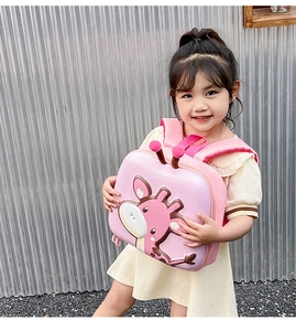 Pink cartoon giraffe eggshell backpack for toddler girls shown with child model