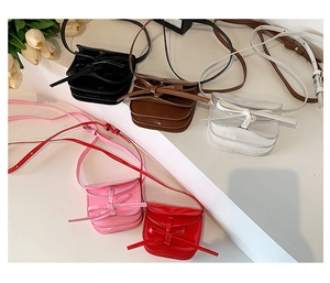 Collection of mini bow crossbody bags in five colors with sleek patent leather finish