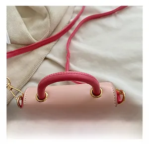 Detail of pink mini bag showing durable handle connection and gold metal rings