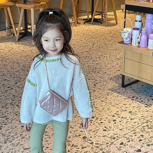 Girl's stylish pink quilted crossbody bag with chain strap and cream knit sweater set