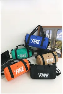 Detail view of colorful cylinder canvas bags with FINE print in 5 vibrant colors
