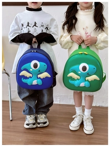 Detail view of cute 3D cartoon dinosaur backpacks in blue and green for children