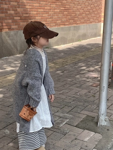 Mini brown printed handbag styled with girls grey cardigan and corduroy cap outfit