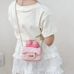 Pink quilted mini crossbody bag for girls featuring a sweet bow and gold chain strap