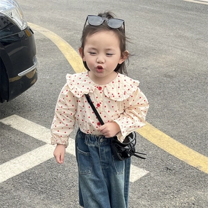 Toddler girl outfit featuring a red polka dot ruffle top and denim skirt with mini bag
