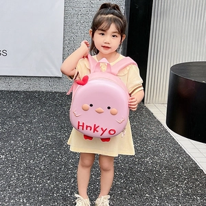 Pink cartoon bird eggshell backpack for kids with 3D details shown on a young girl