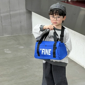 Blue cylindrical canvas crossbody bag for kids with white FINE letter print and black strap