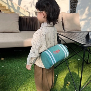 Kids green canvas barrel crossbody bag with white stripes and adjustable black shoulder strap