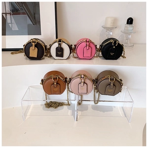 Close-up of mini round bags with lychee pattern leather and retro bronze chains