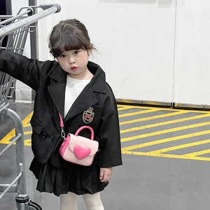 Pink heart-shaped crossbody bag for girls paired with a stylish preppy outfit