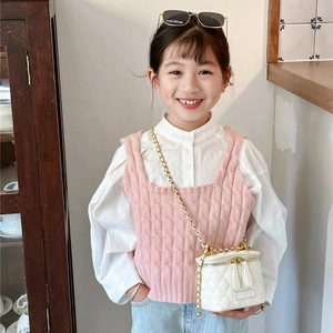 Gilet en tricot rose avec chemise blanche et mini sac seau matelassé à chaîne dorée