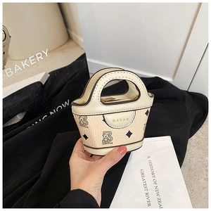 Detail of cream mini PU tote bag featuring cute cartoon bear print and black diamond dots
